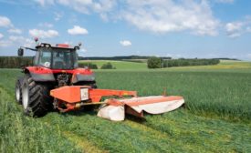 Belgian Farmer mows grass